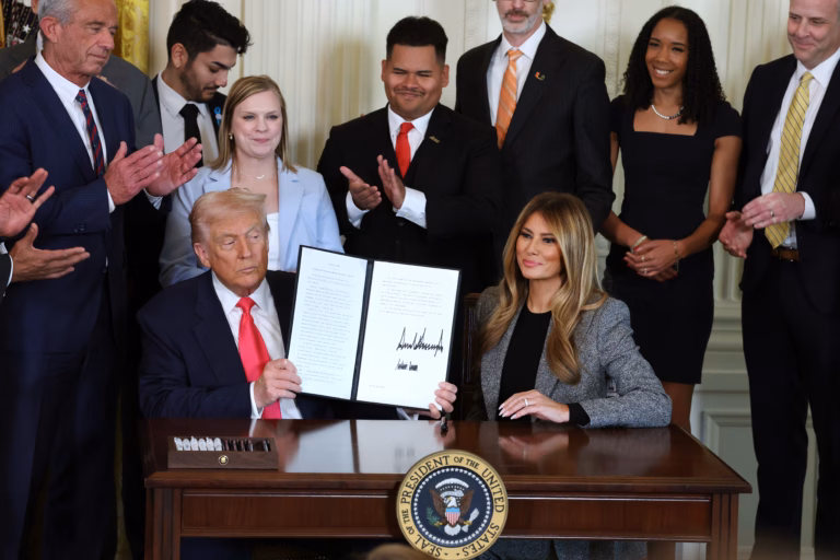 Melania Trump signs executive order with husband to help foster care children